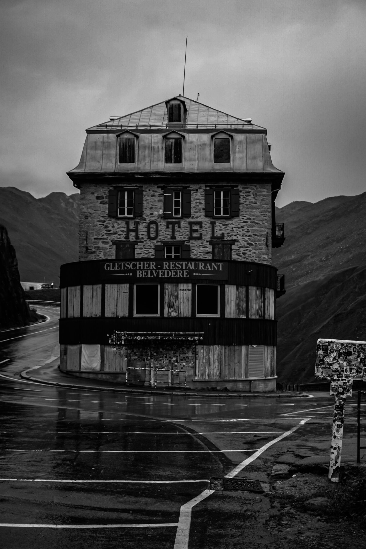 Black and white mountain hotel on a wet alpine pass